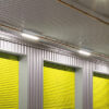 LED Batten Lights mounted above yellow warehouse roller doors