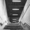 Concrete stairwell lit up by batten lights
