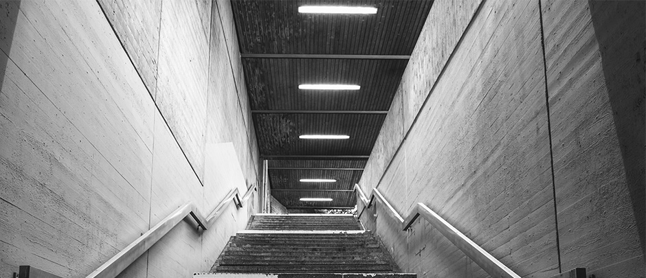 Concrete stairwell lit up by batten lights